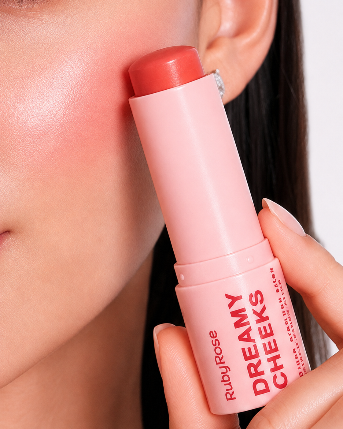 Dreamy Cheeks cream blush stick applied to the cheek